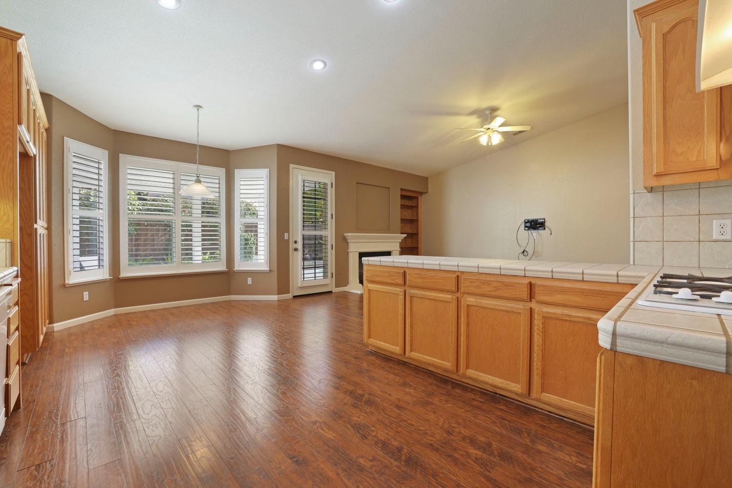 4316 Versailles Drive Modesto, CA 95356 - Photo 10 of 45 a open kitchen with sink cabinets and wooden floor