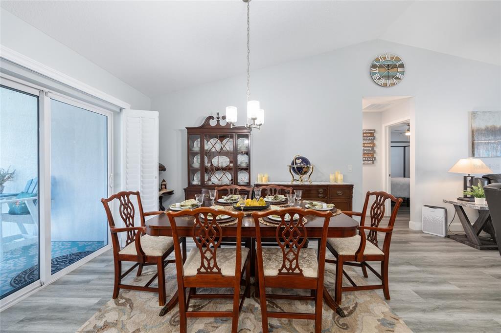 2844 Southwest 164th Street Road Ocala, FL 34473 - Photo 7 of 20 a view of a dining room with furniture and chandelier