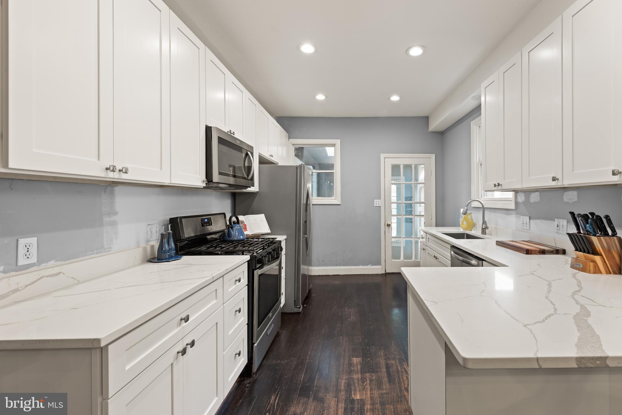 1919 6th Street Northwest Washington, DC 20001 - Photo 11 of 37 a kitchen with a stove a sink a refrigerator and cabinets