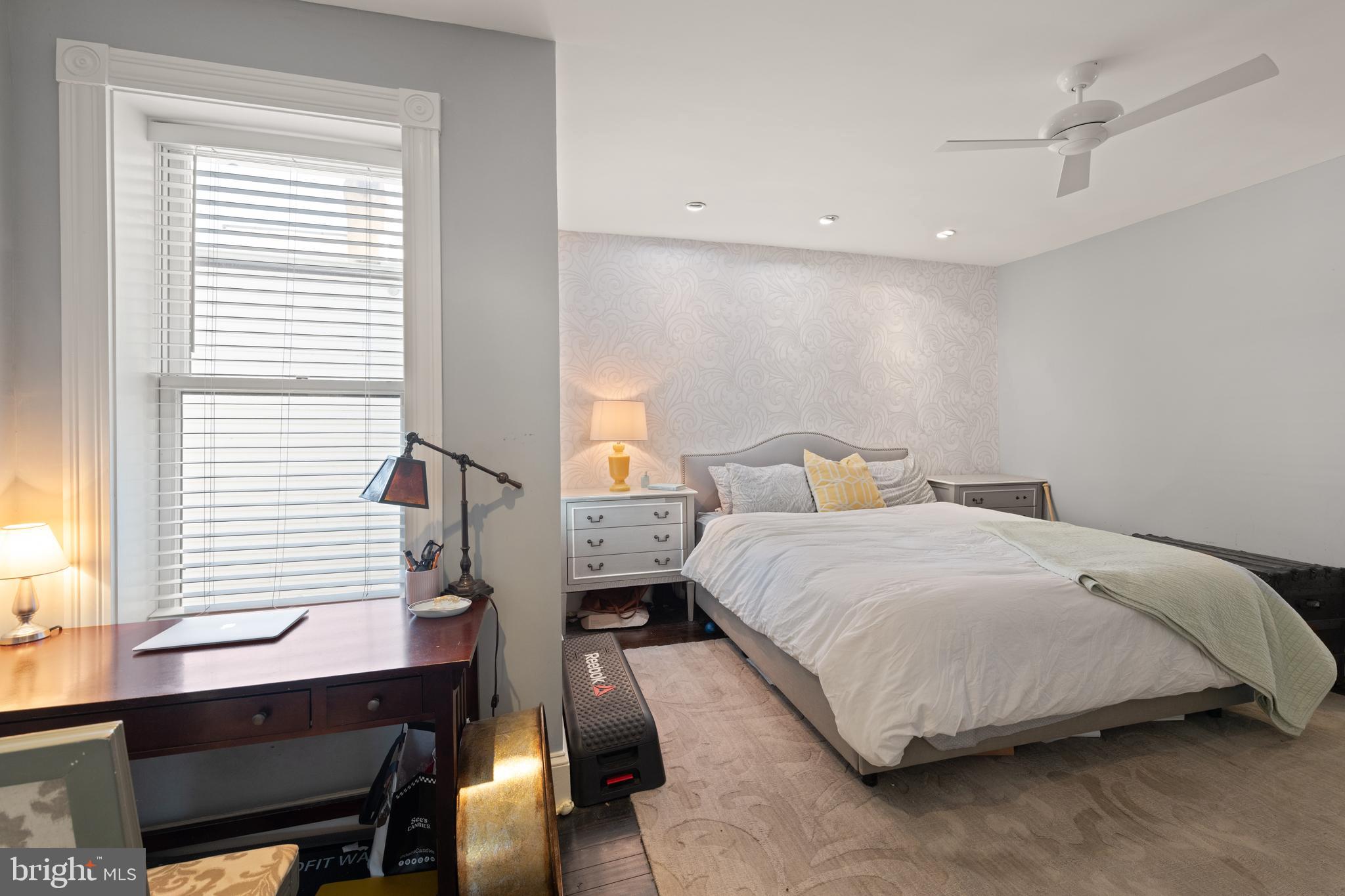 1919 6th Street Northwest Washington, DC 20001 - Photo 17 of 37 a bedroom with a bed a desk and chair with window