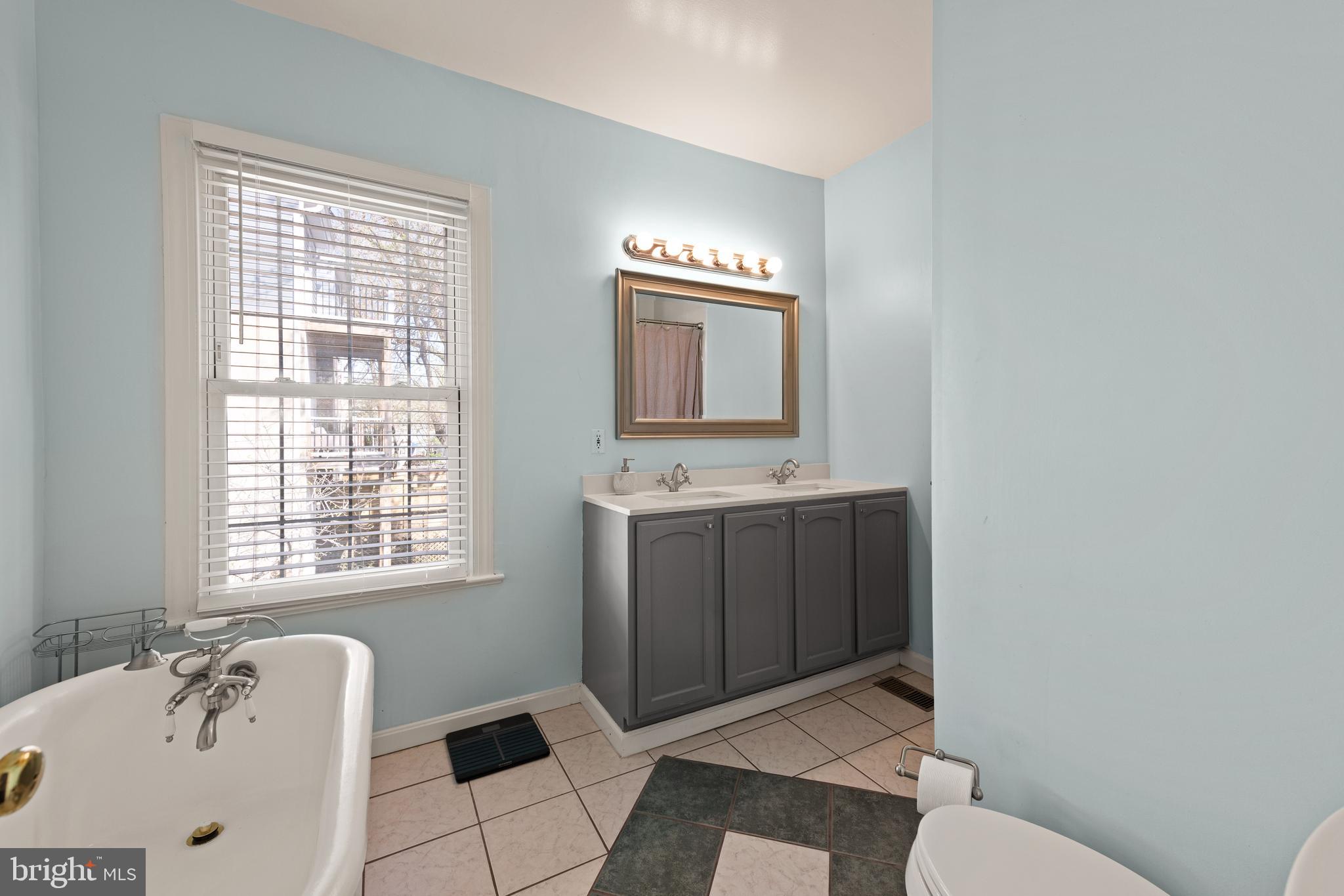 1919 6th Street Northwest Washington, DC 20001 - Photo 18 of 37 a bathroom with a sink a toilet and mirror