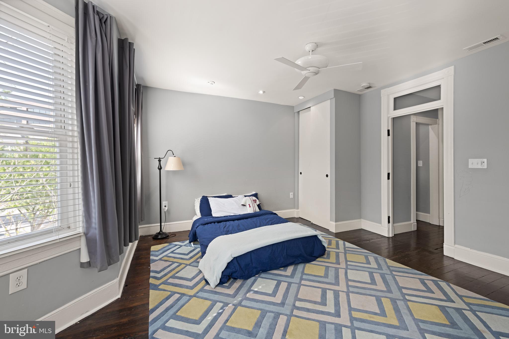 1919 6th Street Northwest Washington, DC 20001 - Photo 22 of 37 a bedroom with a bed and a large mirror next to a window