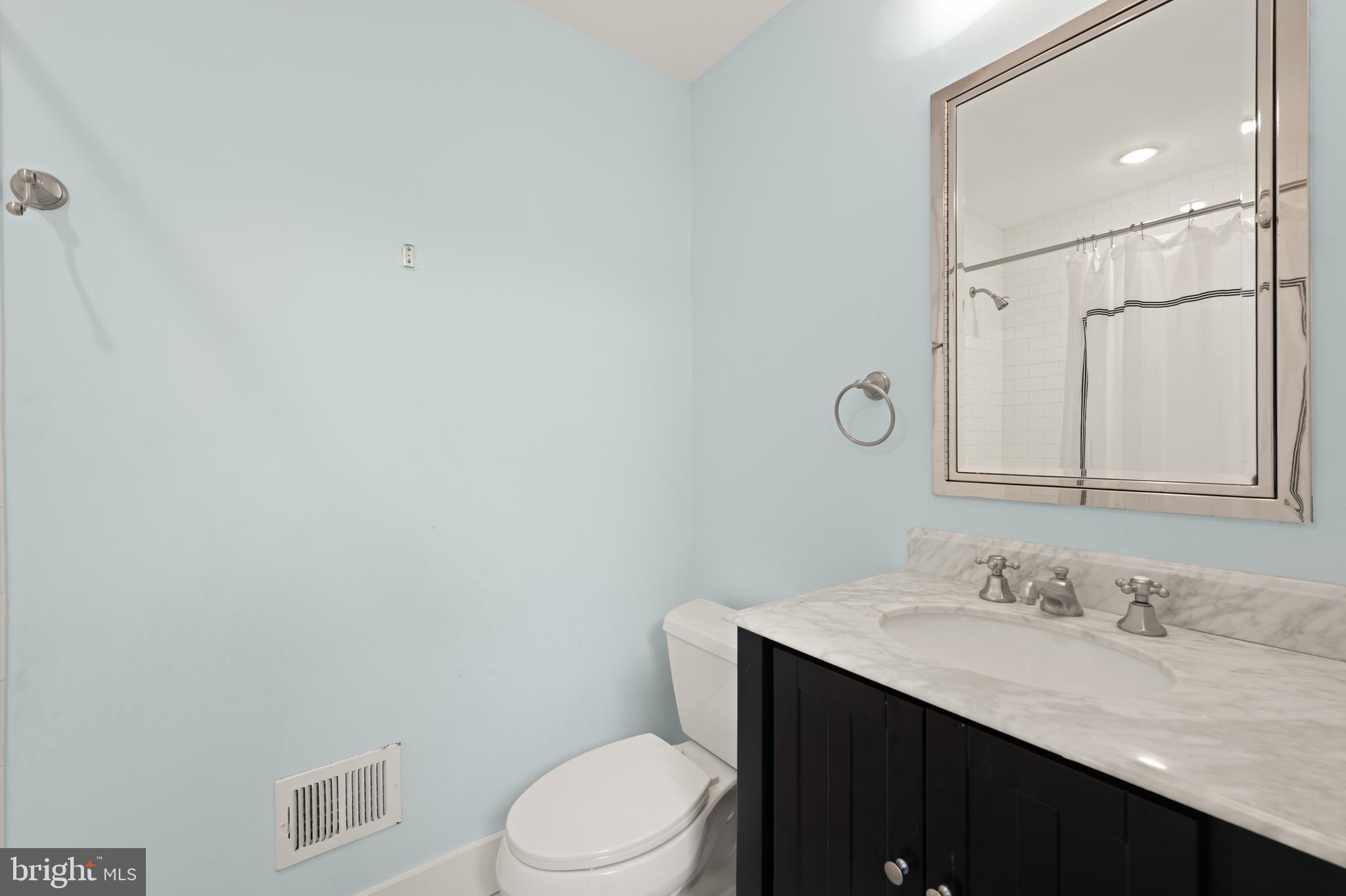 1919 6th Street Northwest Washington, DC 20001 - Photo 24 of 37 a bathroom with a granite countertop sink mirror vanity and toilet