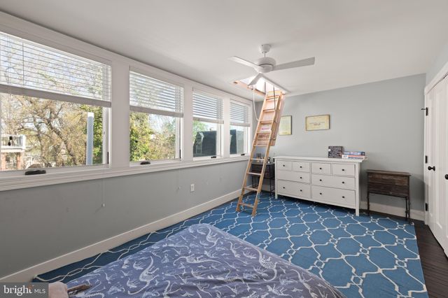 a view of a bedroom with furniture and windows