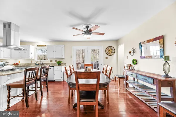 a dining room with furniture a window and wooden floor