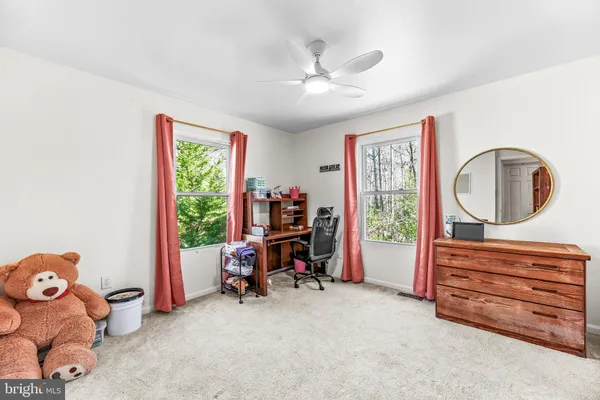 a view of a livingroom with furniture and a window