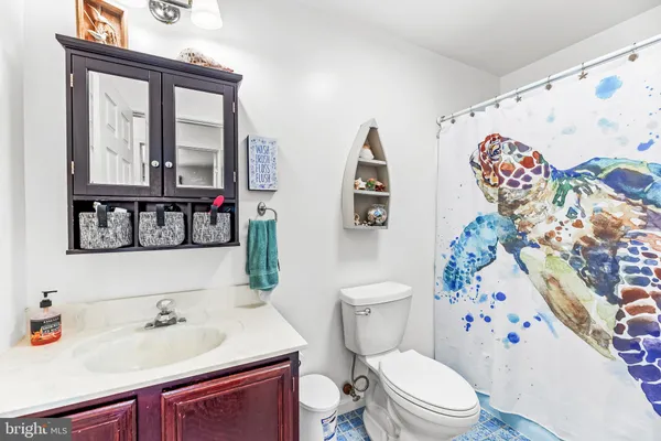 a bathroom with a sink a toilet and a mirror