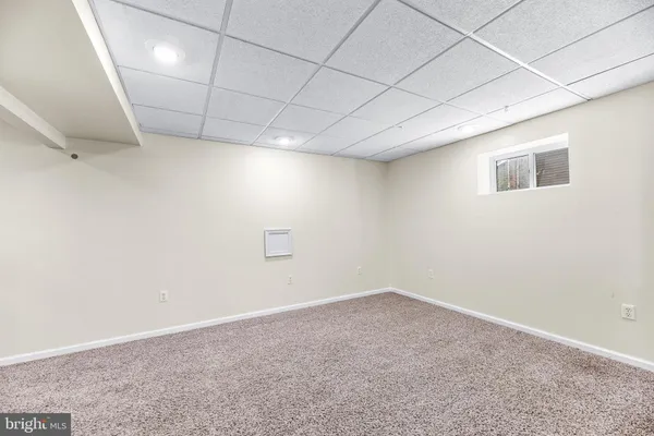 a living room with furniture a ceiling fan and a rug
