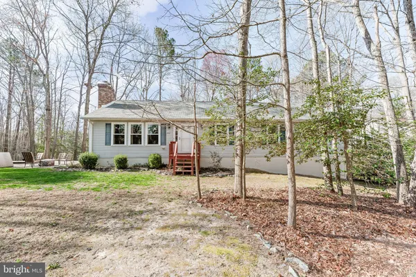a view of a house with a yard and hanging chair