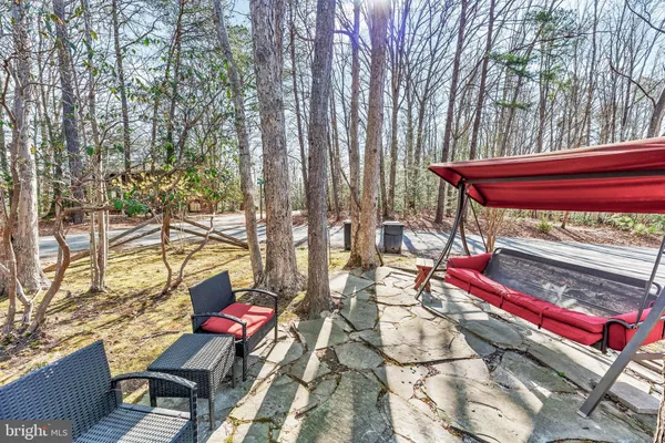 a wooden bench sitting in front of a building