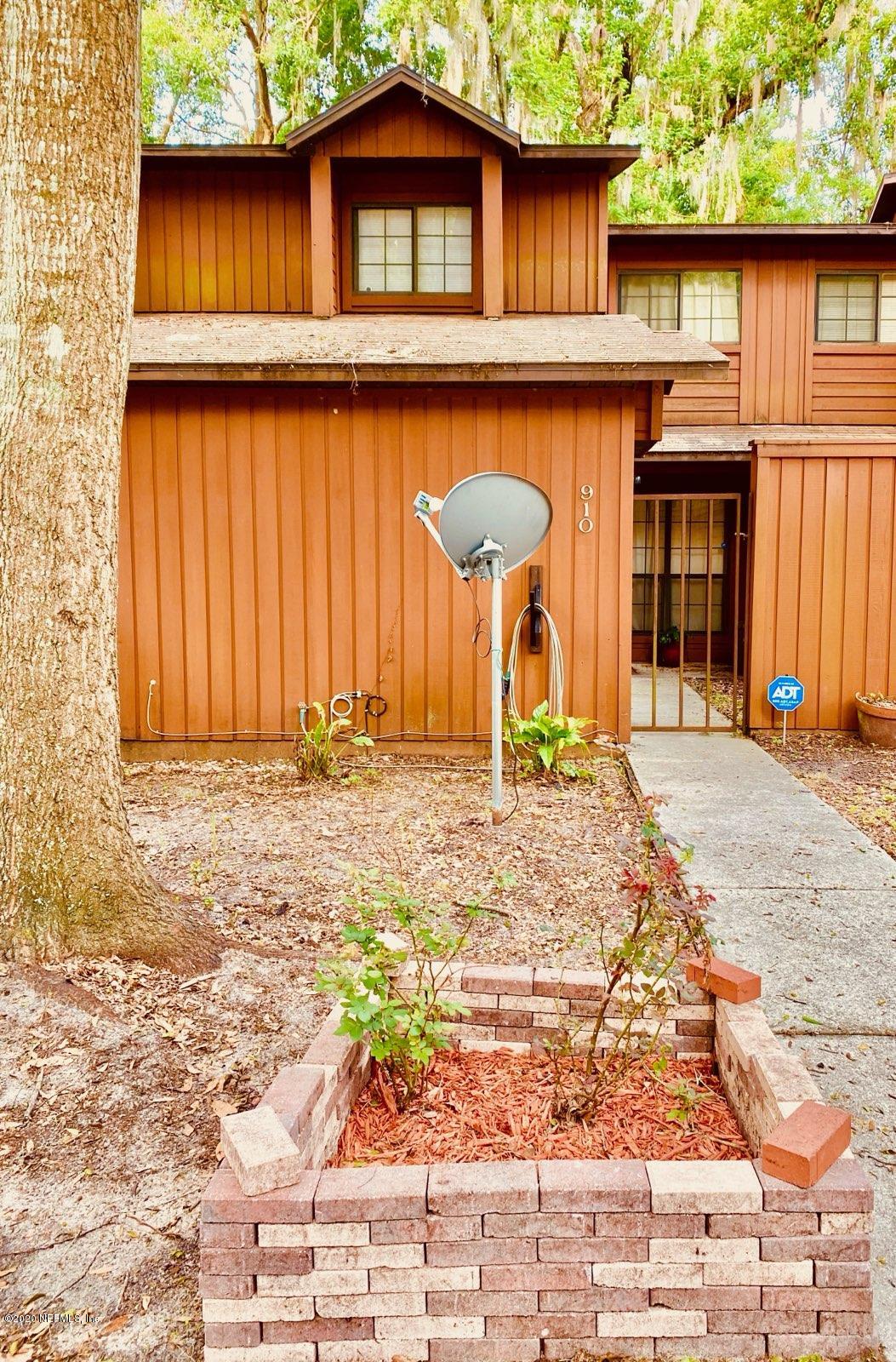 910 Southwest 57 Terrace Gainesville, FL 32607 - Photo 1 of 18 a front view of a house with a yard