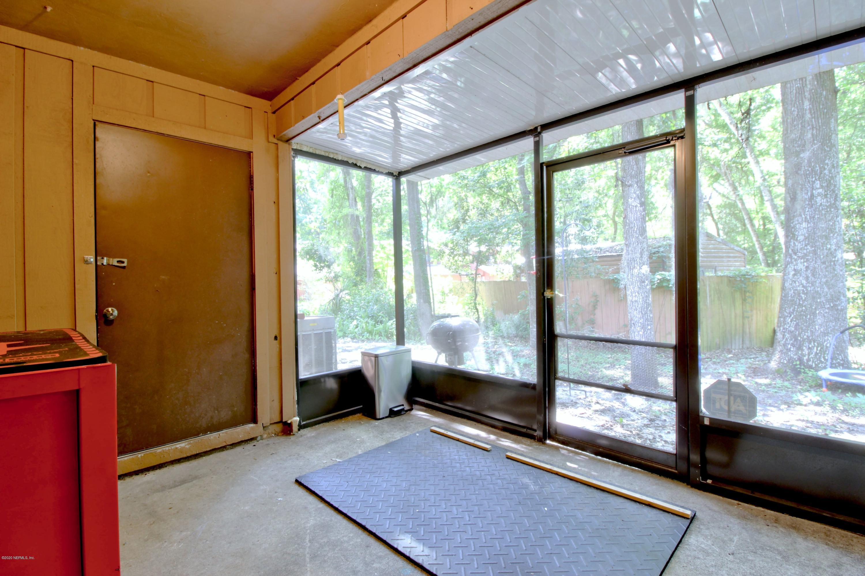 910 Southwest 57 Terrace Gainesville, FL 32607 - Photo 18 of 18 a living room with a large window