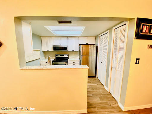 910 Southwest 57 Terrace Gainesville, FL 32607 - Photo 2 of 18 a kitchen with stainless steel appliances a refrigerator and a stove top oven