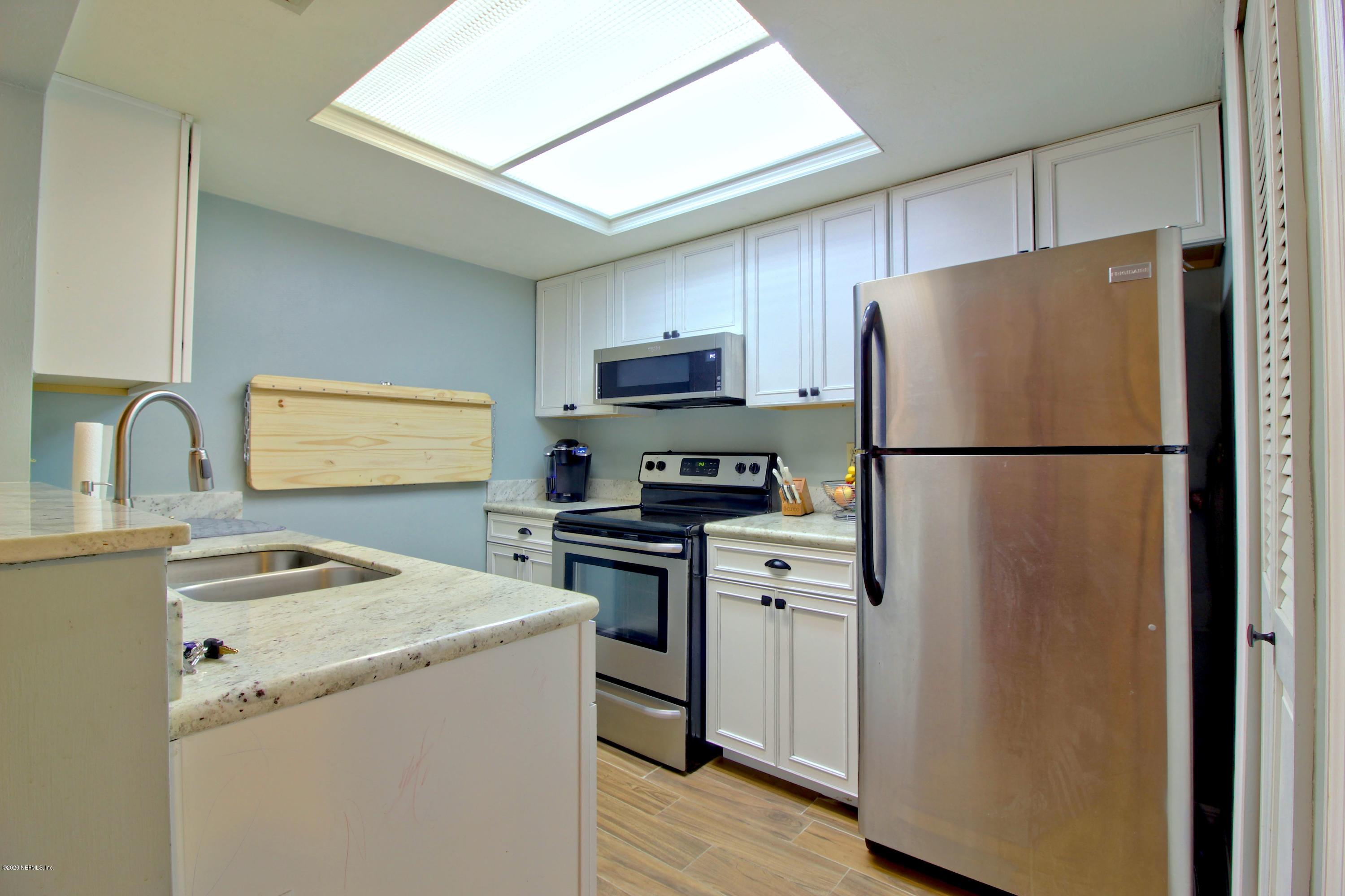 910 Southwest 57 Terrace Gainesville, FL 32607 - Photo 4 of 18 a kitchen with a refrigerator sink and stove