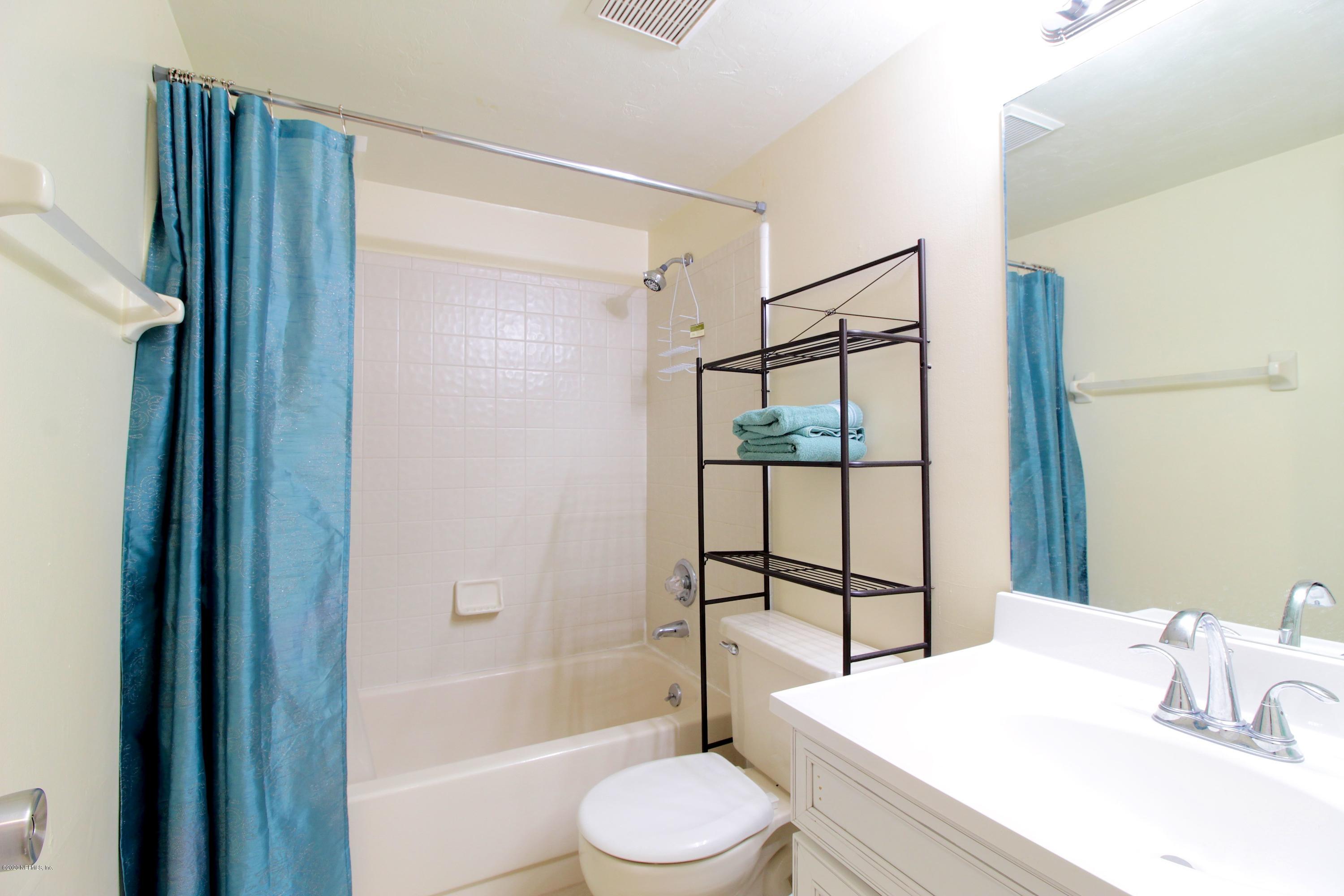 910 Southwest 57 Terrace Gainesville, FL 32607 - Photo 9 of 18 a bathroom with a sink toilet and shower