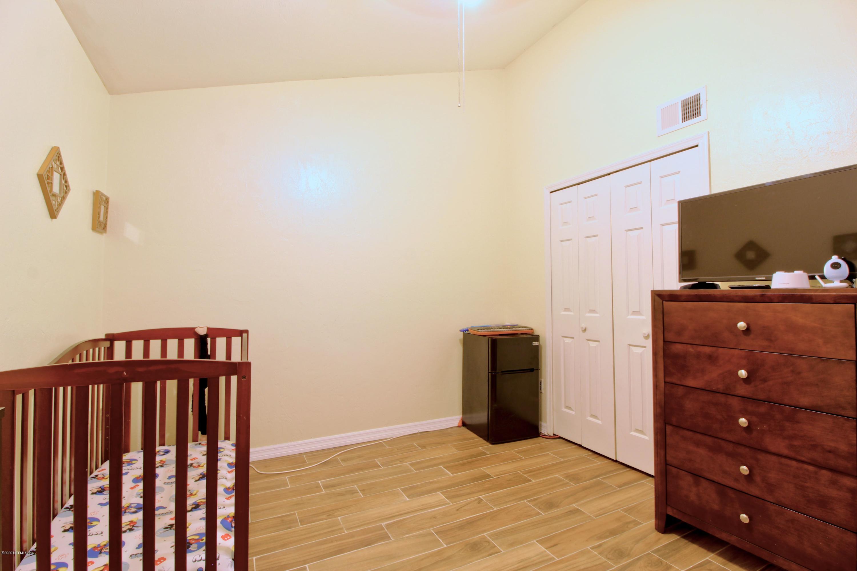 910 Southwest 57 Terrace Gainesville, FL 32607 - Photo 10 of 18 a view of a bedroom with wooden floor