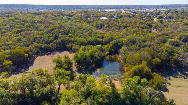 an aerial view of a houses with a yard