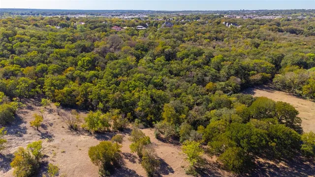 an aerial view of a houses with a yard