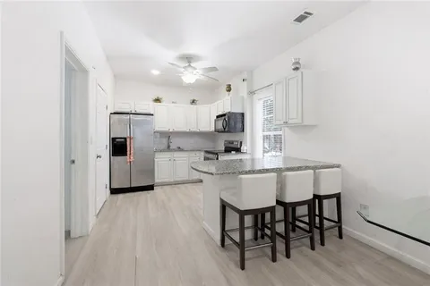 a view of a workspace with furniture and gym equipment