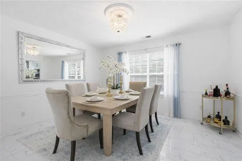 a view of a dining room with furniture and a window