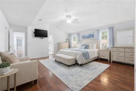 a bedroom with a large bed and a tv