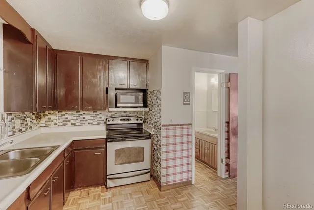 a kitchen with sink cabinets and stainless steel appliances
