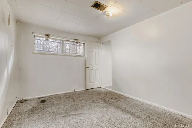 an empty room with a empty space and windows