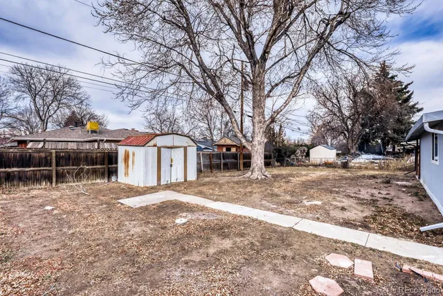a front view of a house with a yard covered with snow