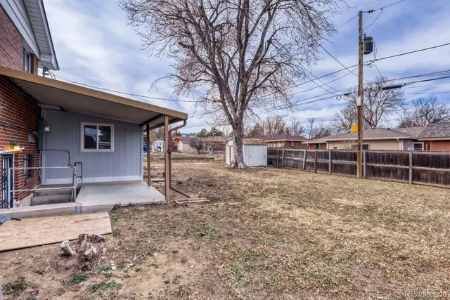 a view of a backyard with wooden fence