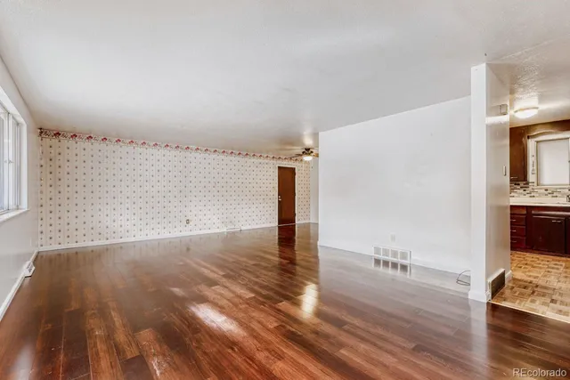 a view of a room with wooden floor
