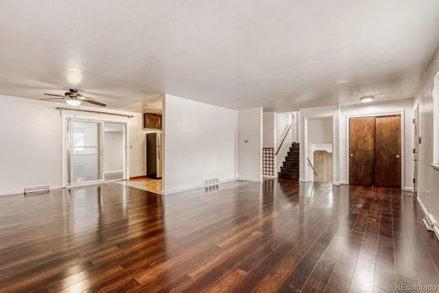 a view of empty room with wooden floor