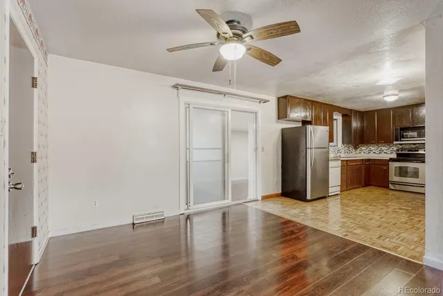 a kitchen with stainless steel appliances a refrigerator and a stove top oven