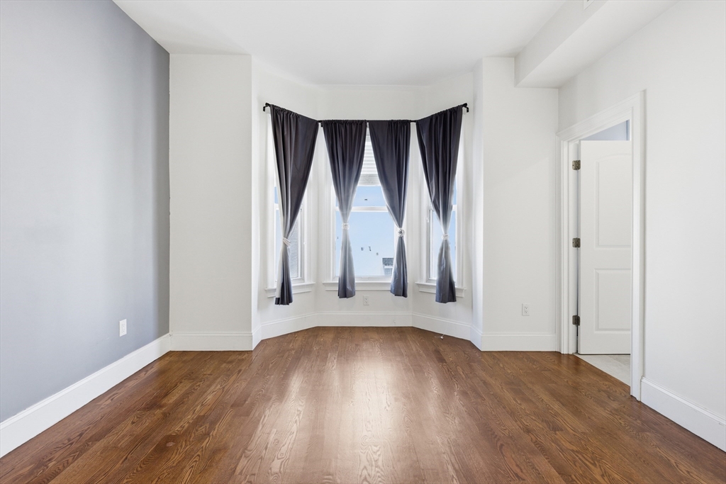 249 Lexington Street, Unit 2 Boston, MA 02128 - Photo 5 of 24 a view of wooden floor and brick walls