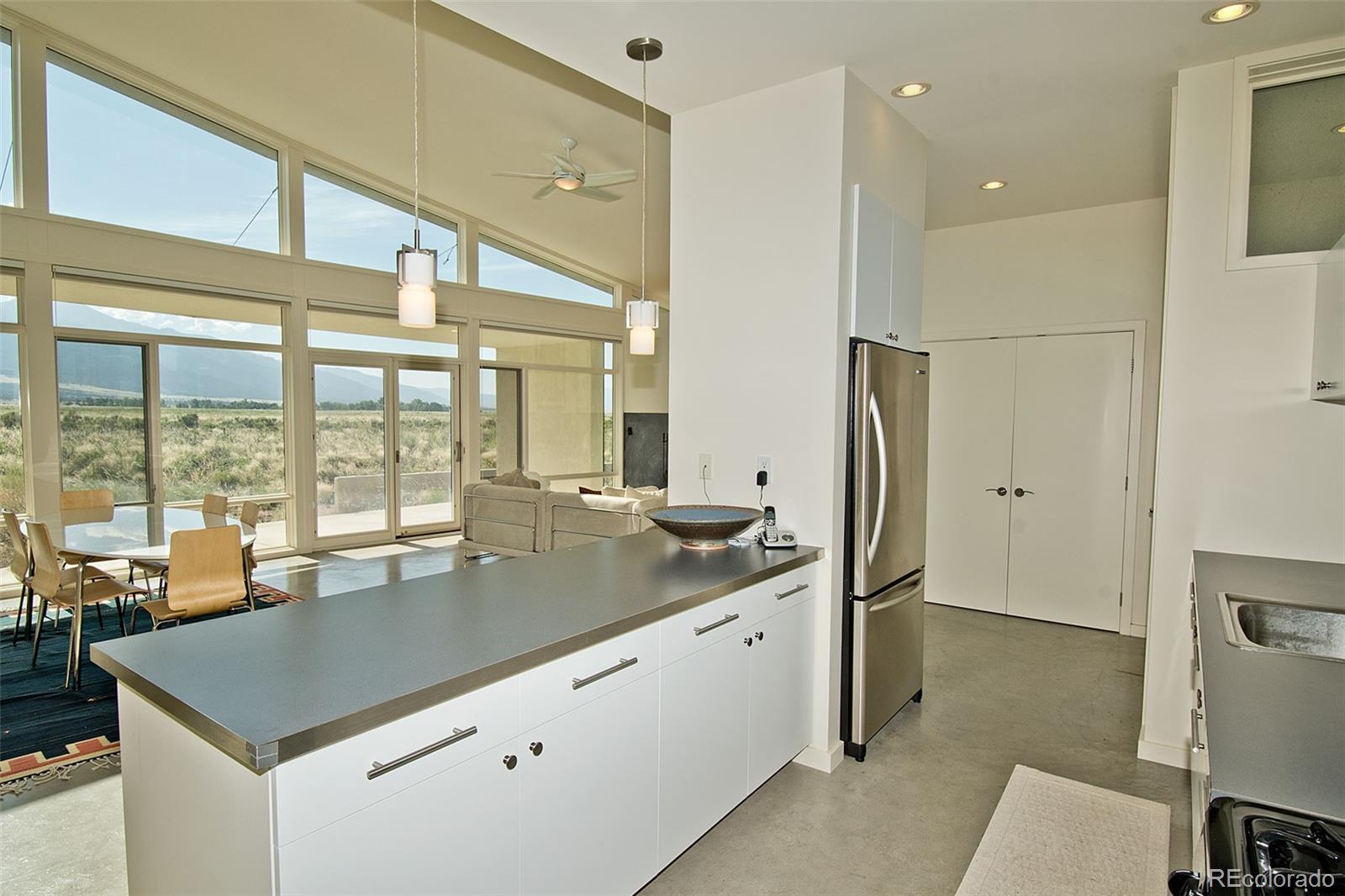790 Birch Road Crestone, CO 81131 - Photo 13 of 38 a kitchen with stainless steel appliances granite countertop a sink and a refrigerator