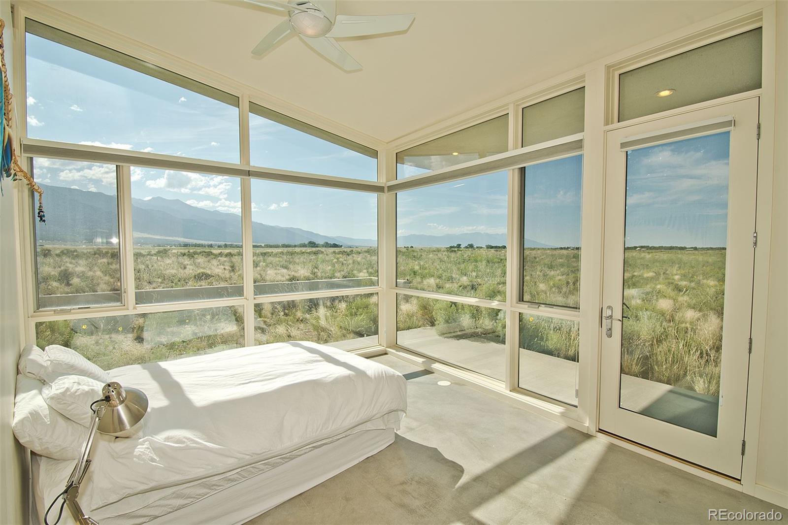 790 Birch Road Crestone, CO 81131 - Photo 18 of 38 a bed sitting in a bedroom next to a window