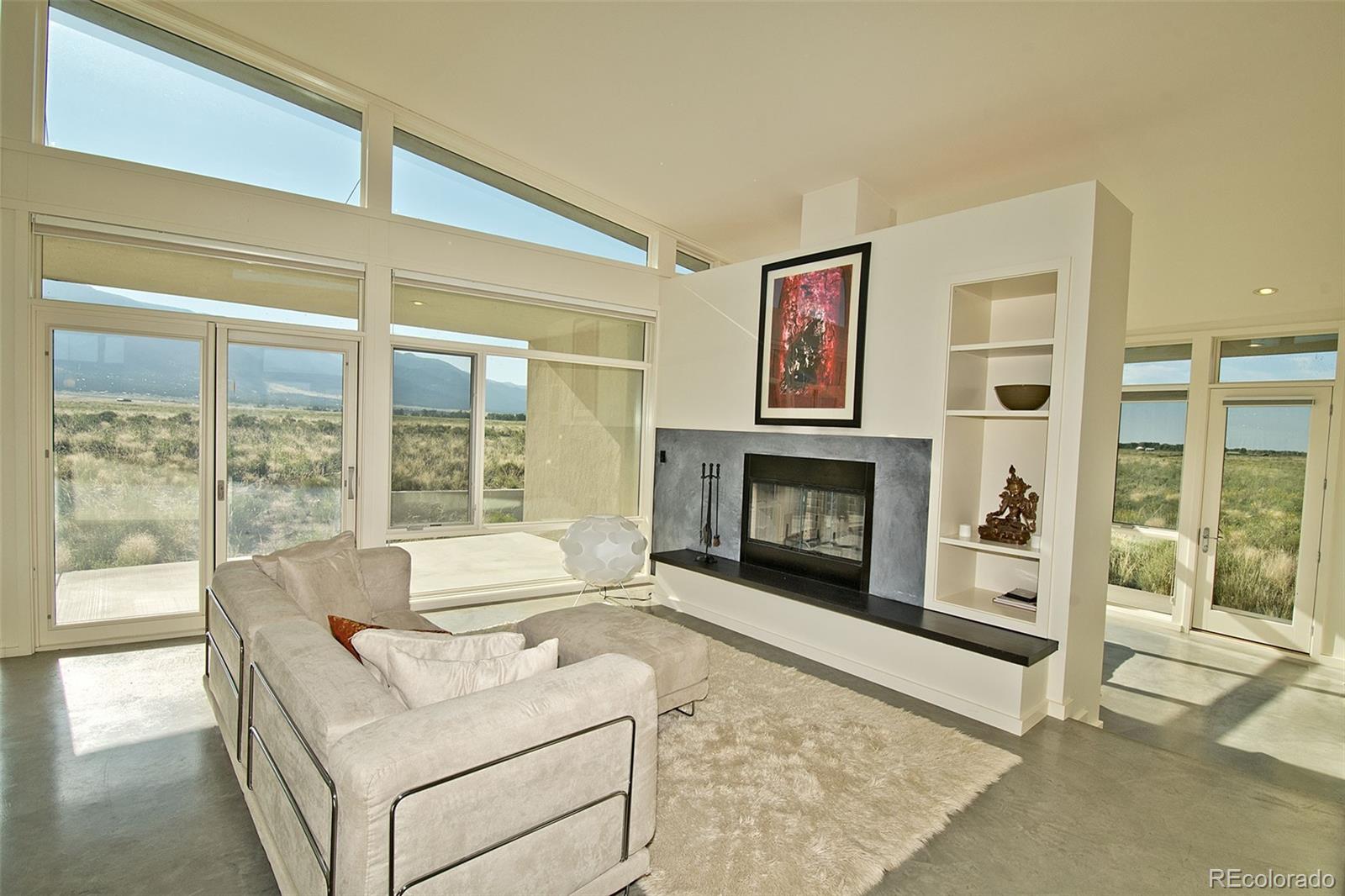 790 Birch Road Crestone, CO 81131 - Photo 2 of 38 a living room with furniture and a fireplace