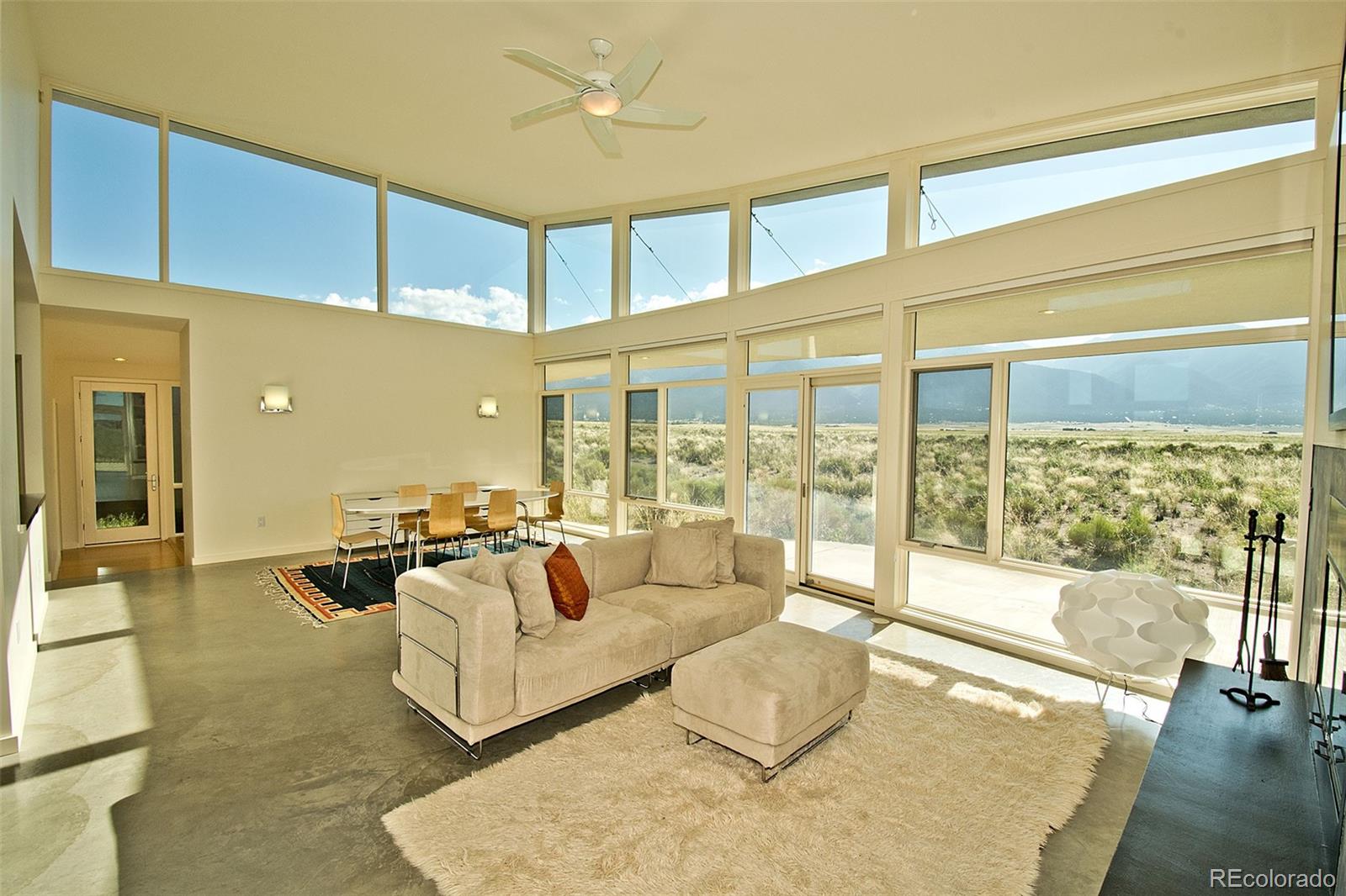790 Birch Road Crestone, CO 81131 - Photo 4 of 38 a living room with furniture and a large window