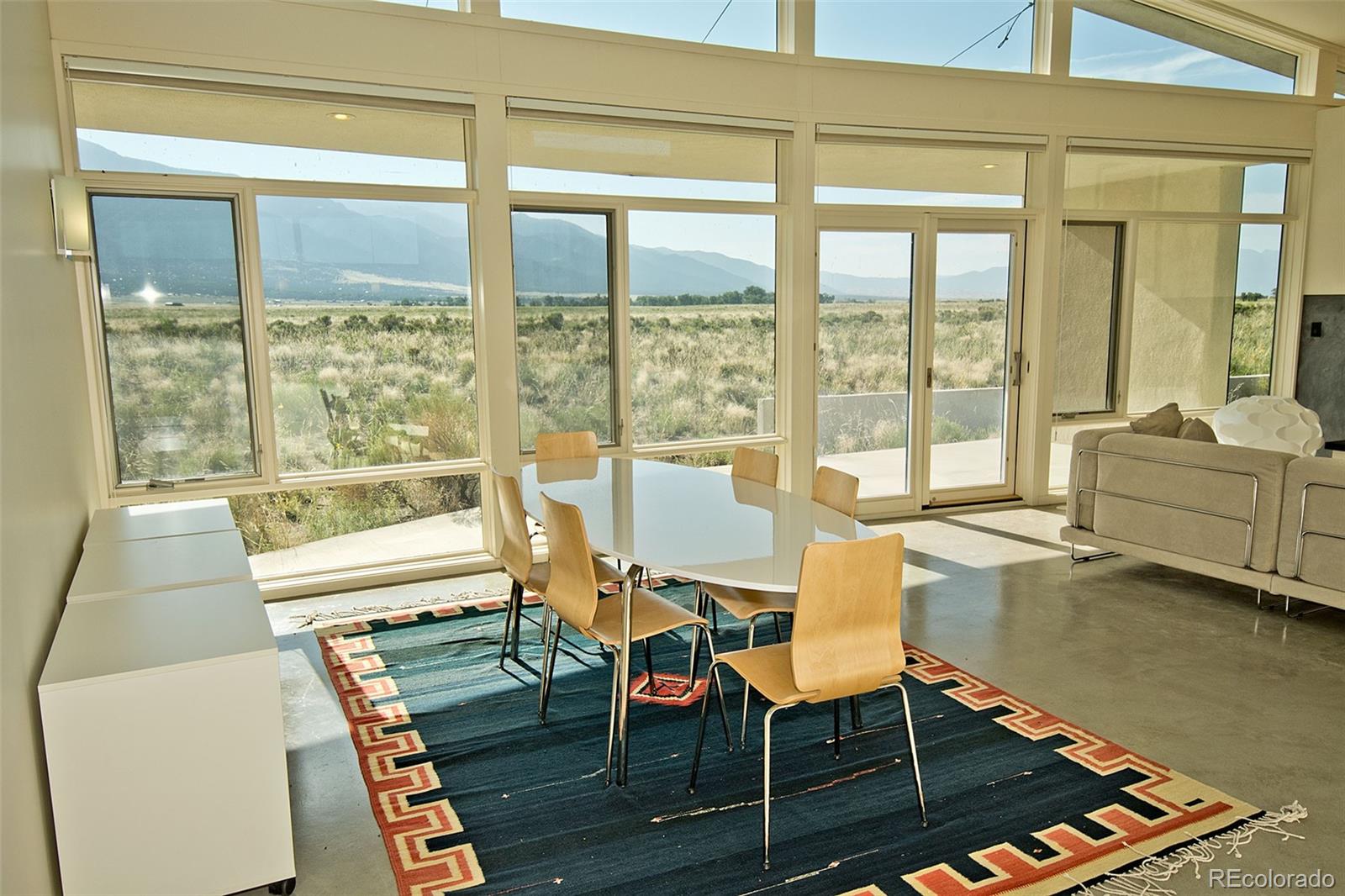 790 Birch Road Crestone, CO 81131 - Photo 5 of 38 a dining room with furniture water view and wooden floor