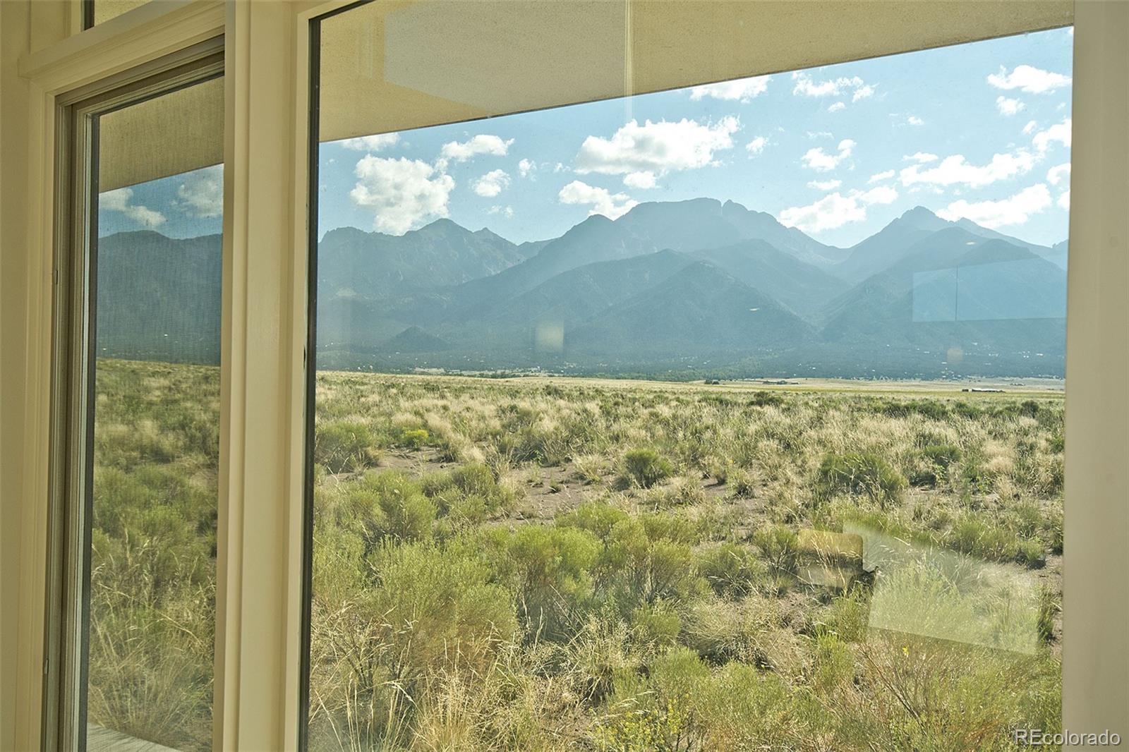 790 Birch Road Crestone, CO 81131 - Photo 7 of 38 a view of a window with a tree in front of it