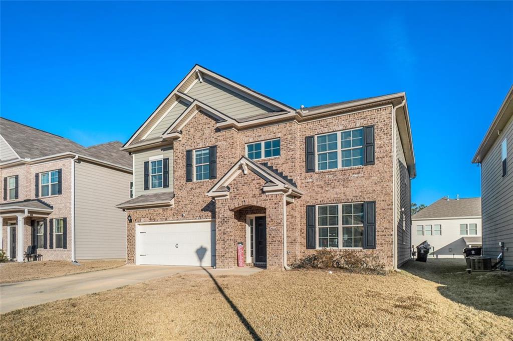 a front view of a house with a yard