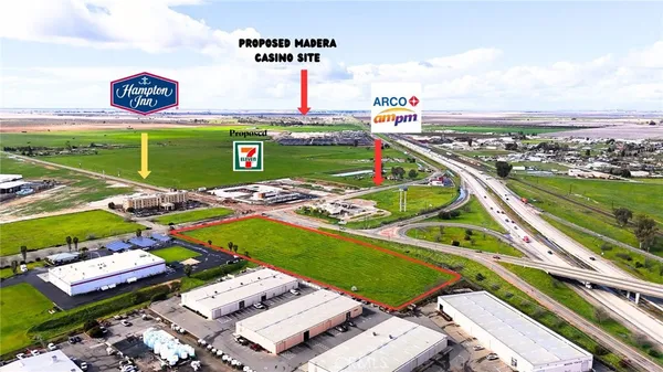 a view of a tennis ground with a table and chairs