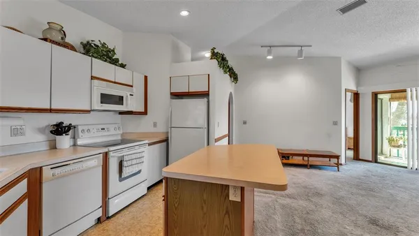 a kitchen with stainless steel appliances granite countertop a sink stove and microwave