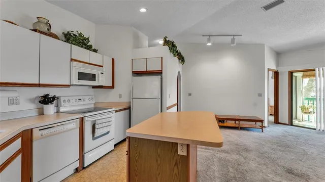a kitchen with stainless steel appliances granite countertop a sink stove and microwave