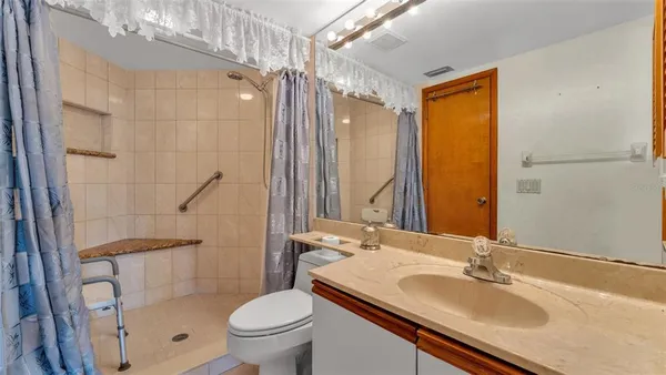 a bathroom with a sink toilet double vanity and shower