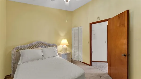 a bedroom with a bed and a mirror