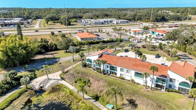 an aerial view of a houses with a lake