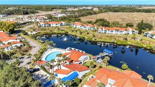 an aerial view of a house with a yard and outdoor seating