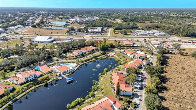 an aerial view of a house with a yard and lake view