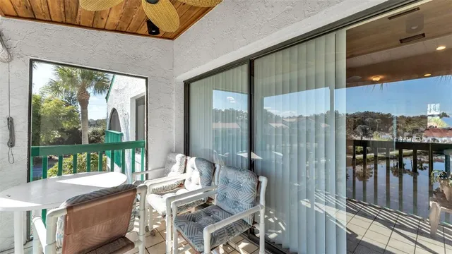a view of a chairs and table in patio of the house