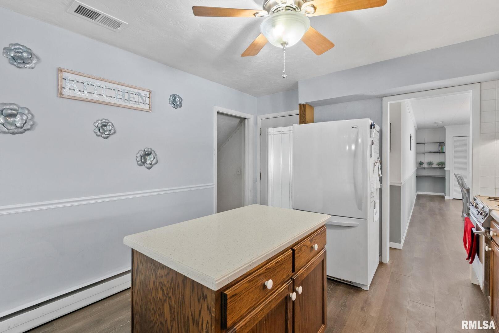 301 North Washington Street Atkinson, IL 61235 - Photo 18 of 45 a kitchen with a refrigerator a stove cabinets and wooden floor